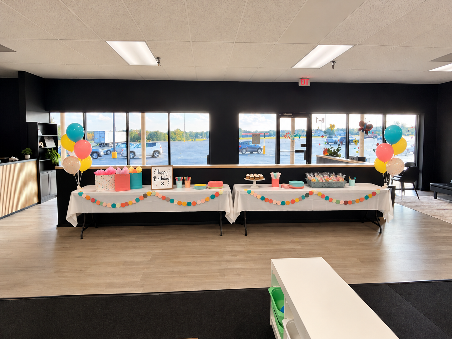 Birthday party tables with balloons and colorful decorations inside The Plays2b